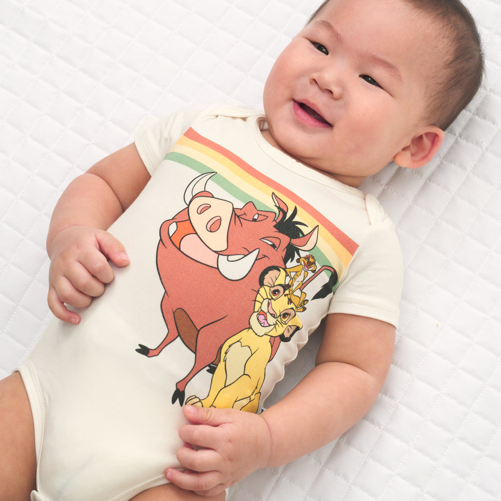 Close up image of a child wearing a Lion King graphic bodysuit