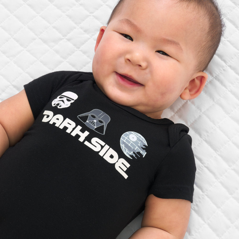 Close up image of a child wearing a Dark Side graphic bodysuit