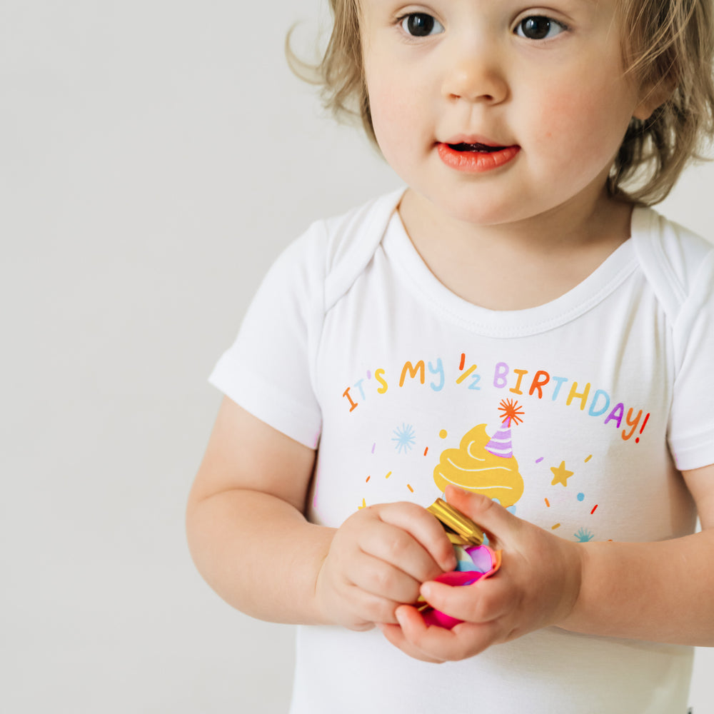 Alternative close up image of a child wearing a It's my Half Birthday graphic bodysuit