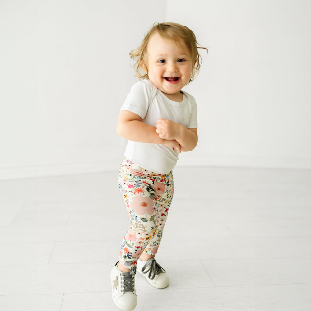 Child wearing Mauve Meadow leggings and coordinating Play bodysuit