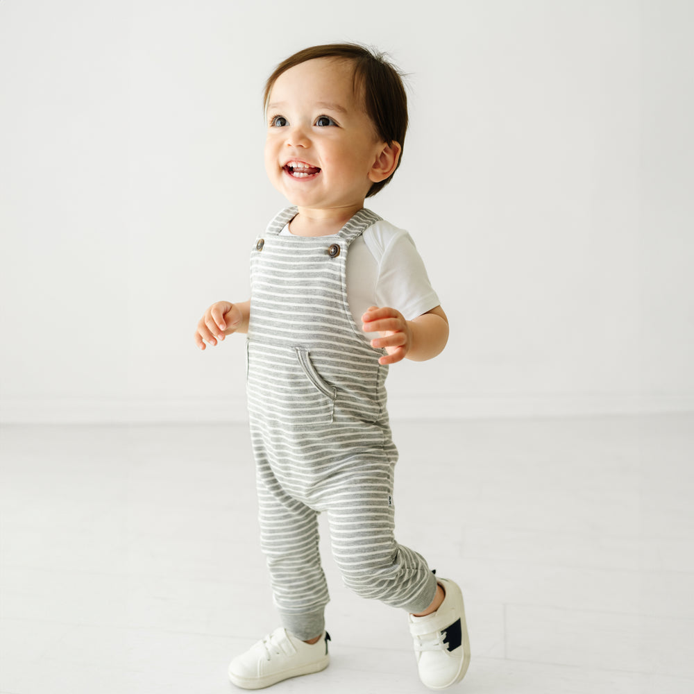 Child wearing a Bright White bodysuit and coordinating Play overall