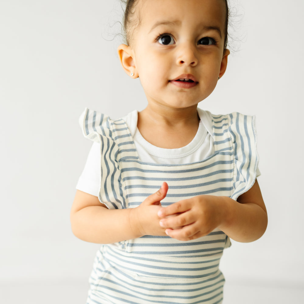 Alternate close up image of a child wearing Fog Stripes ruffle overall and coordinating Play bodysuit