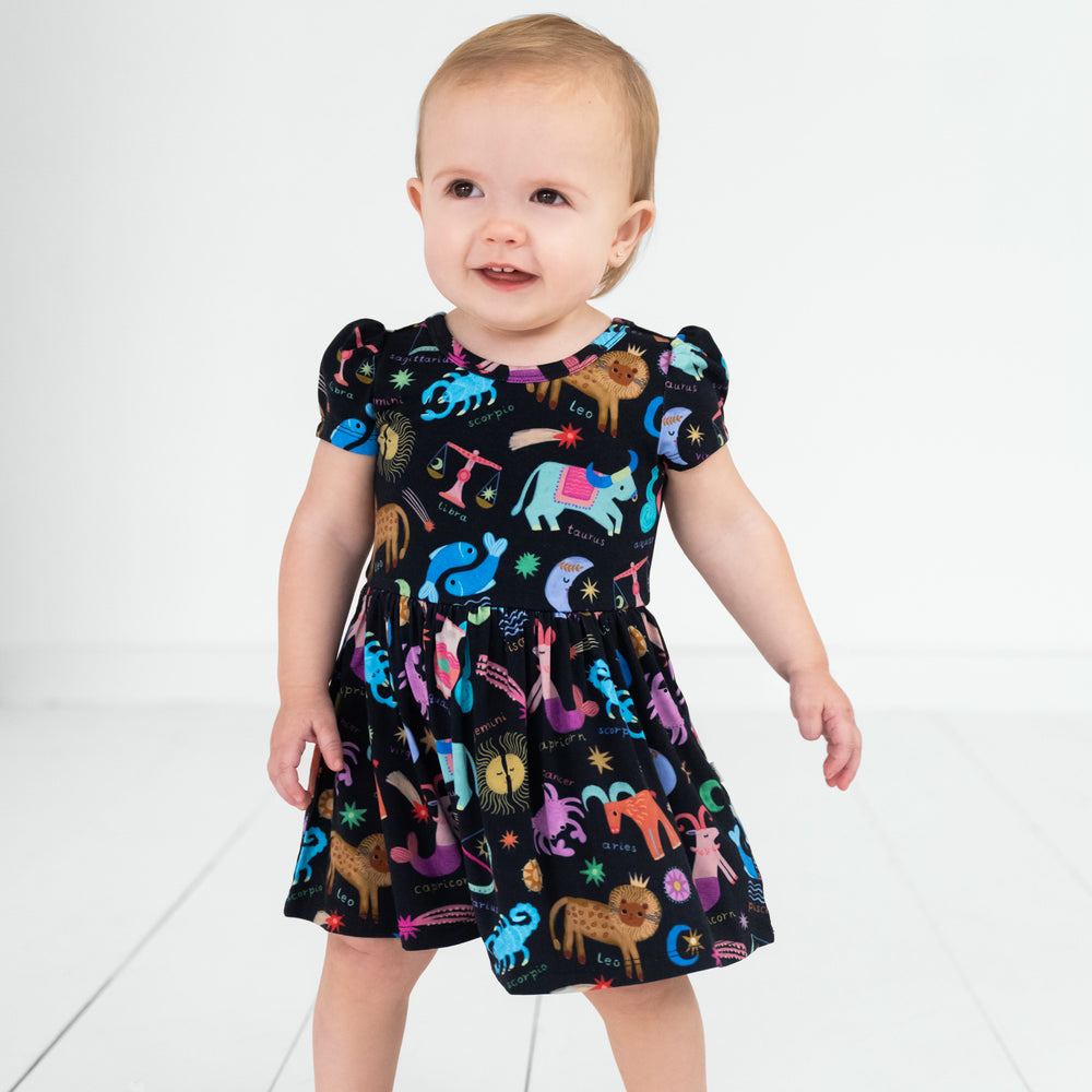 child wearing a star signs skater dress with bodysuit