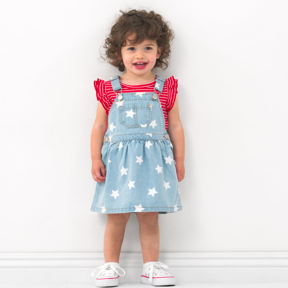 Child wearing a Denim Stars tank skirt overall and coordinating Play bodysuit