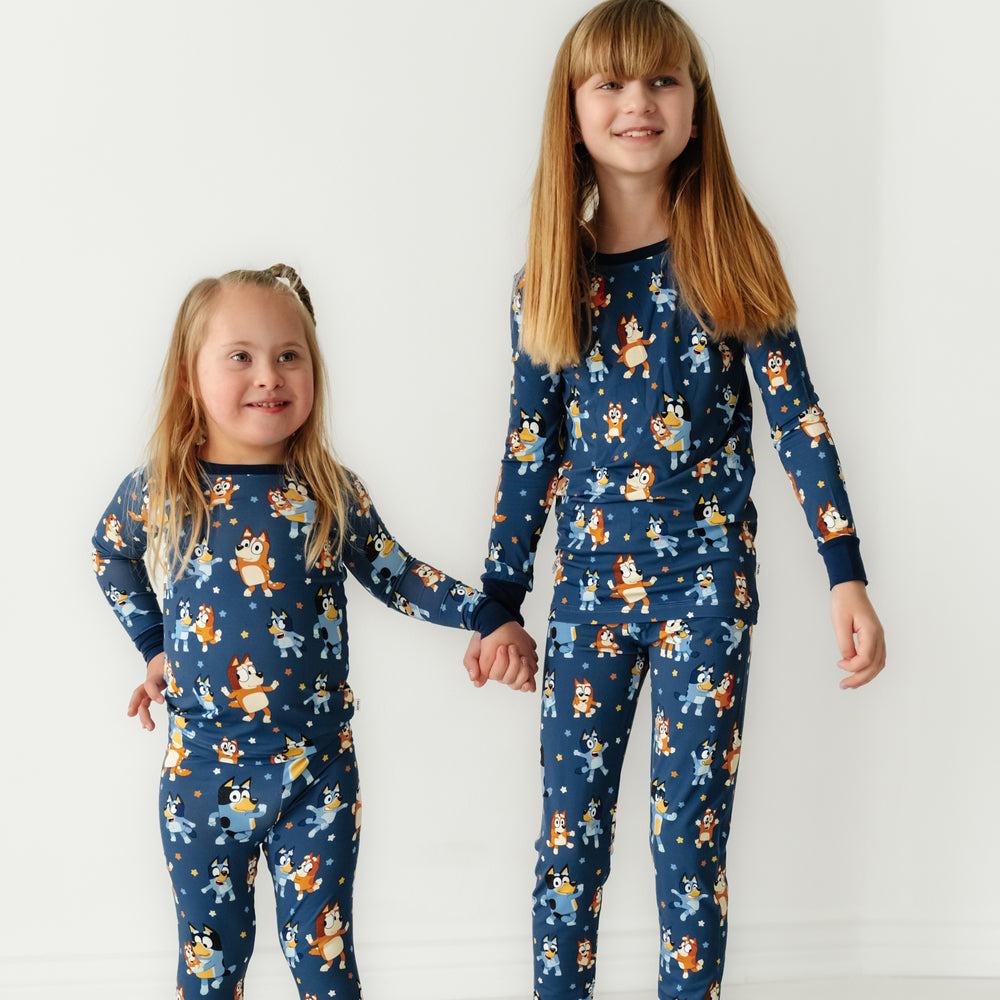 Two children dancing wearing a Bluey Dance Mode two piece pajama sets