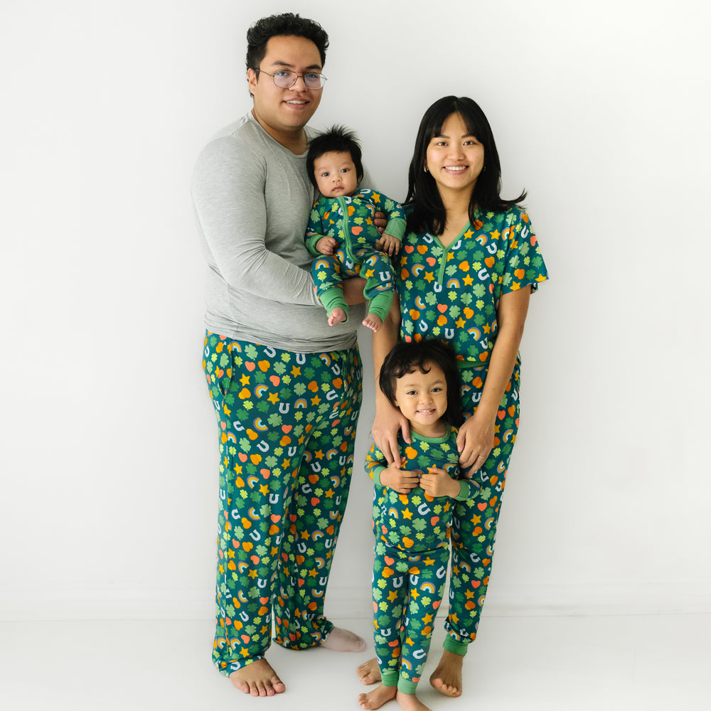 Click to see full screen - Family of four wearing matching Lucky printed pajamas. Dad is wearing a men's solid Heather Gray pajama top and Lucky printed men's pajama pants. Mom is wearing a women's Lucky printed pajama top and matching pajama pants. Their children are matching wearing Lucky printed two piece pajama set and zippy.