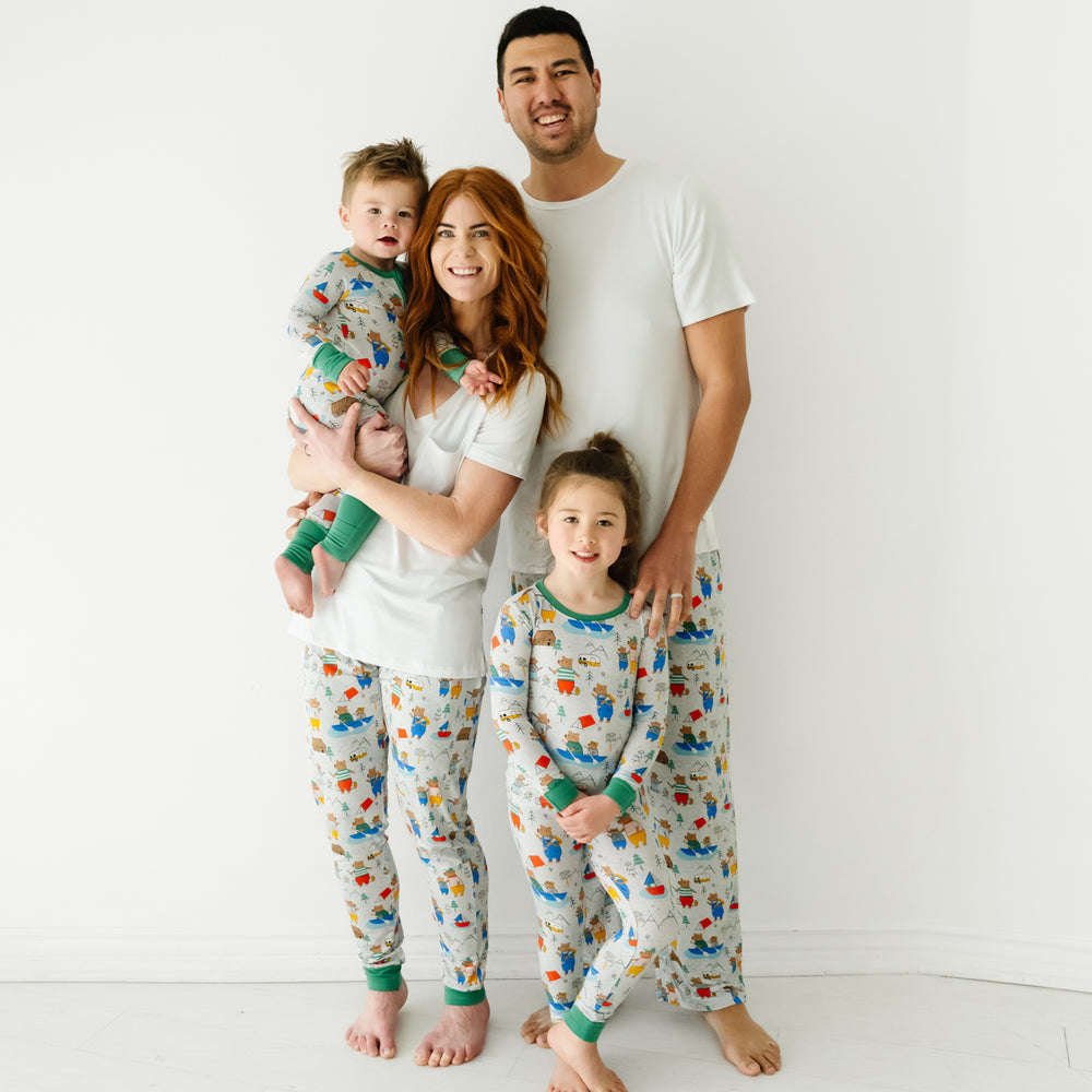 Family of four posing together wearing matching Papa Bear Pjs. Mom is wearing women's Papa Bear pj pants and a women's Bright White perfect pocket tee. Dad is wearing men's Papa Bear pj pants and a men's Bright White pj top. Children are wearing matching Papa Bear pjs in zippy and two piece styles