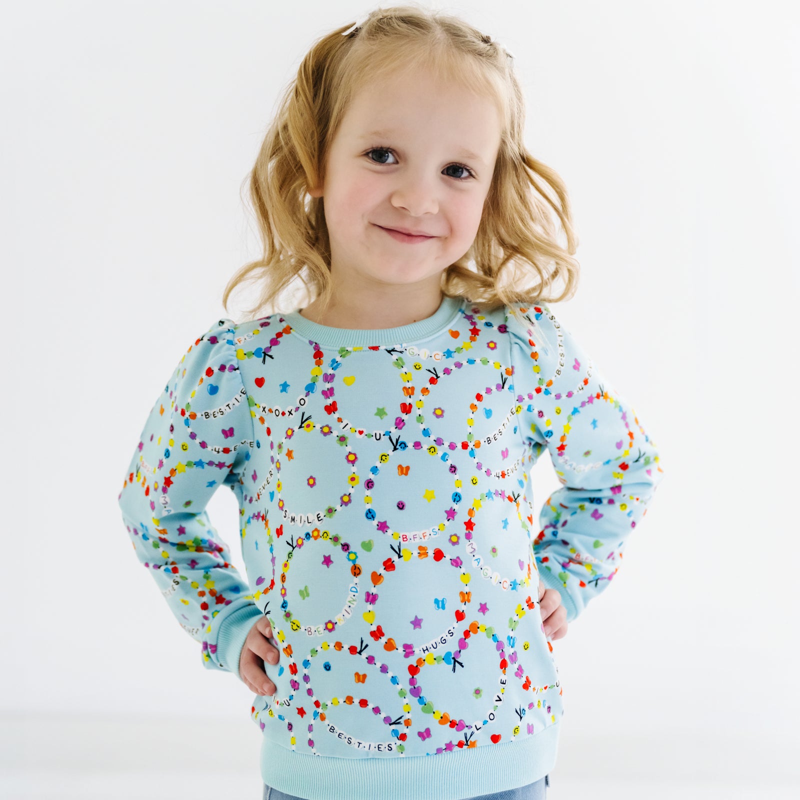 Child posing in a friends forever puff sleeve crewneck