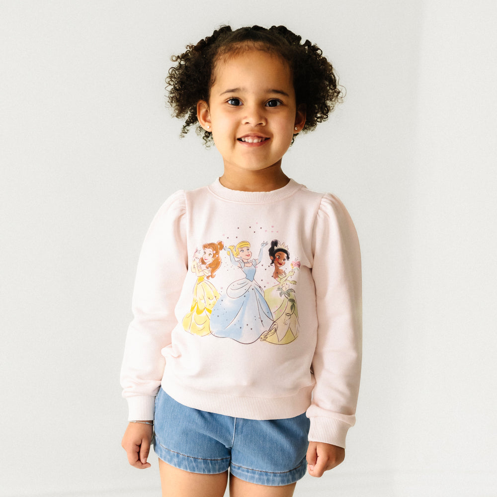 Child wearing a Disney Princesses puff sleeve crewneck and coordinating Play shorts