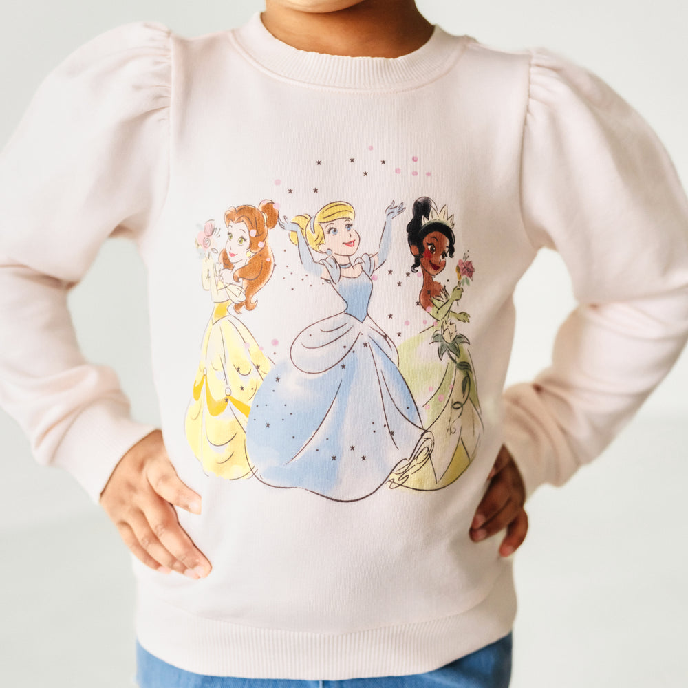 Close up image of a child wearing a Disney Princesses puff sleeve crewneck