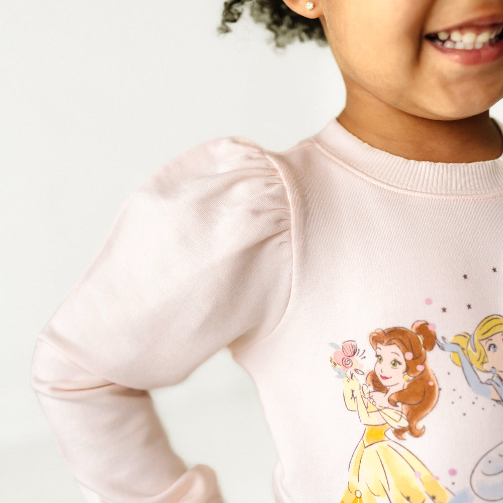 Alternate close up image of a child wearing a Disney Princesses puff sleeve crewneck