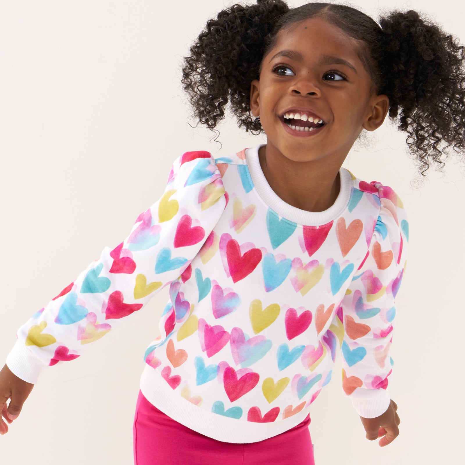 Close up image of a child wearing a Watercolor Love puff sleeve crewneck
