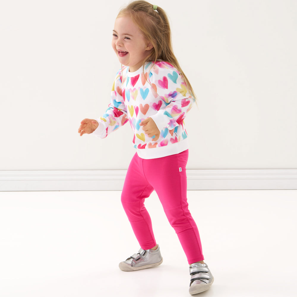 Click to see full screen - Child wearing a Watercolor Love puff sleeve crewneck and coordinating leggings