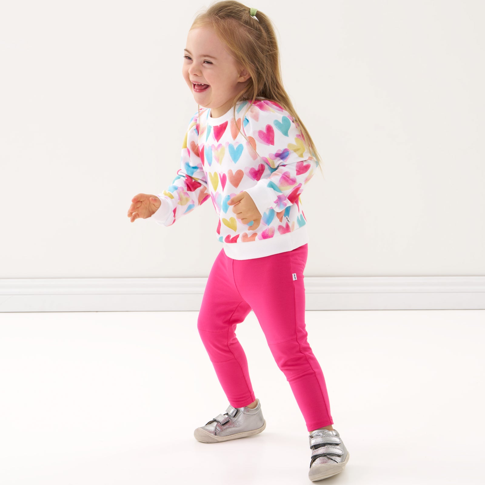 Child wearing a Watercolor Love puff sleeve crewneck and coordinating leggings