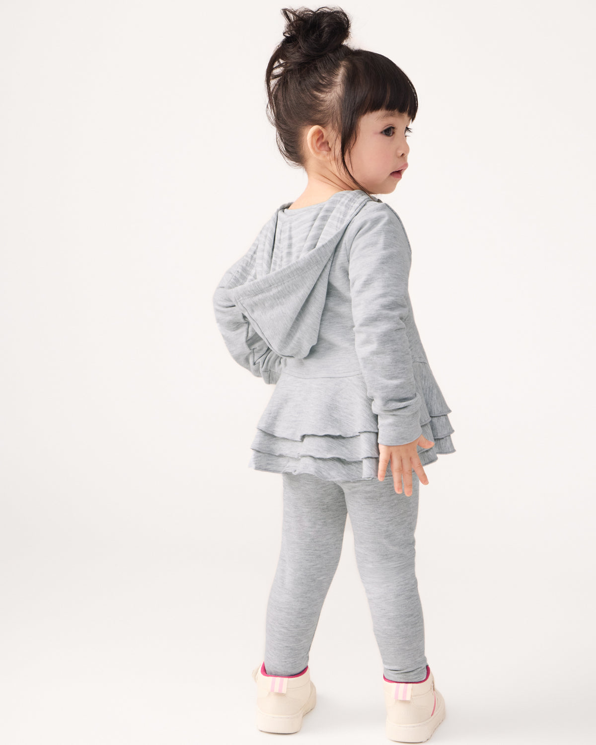 Back view of child wearing the Light Heather Gray Peplum Hoodie and Leggings