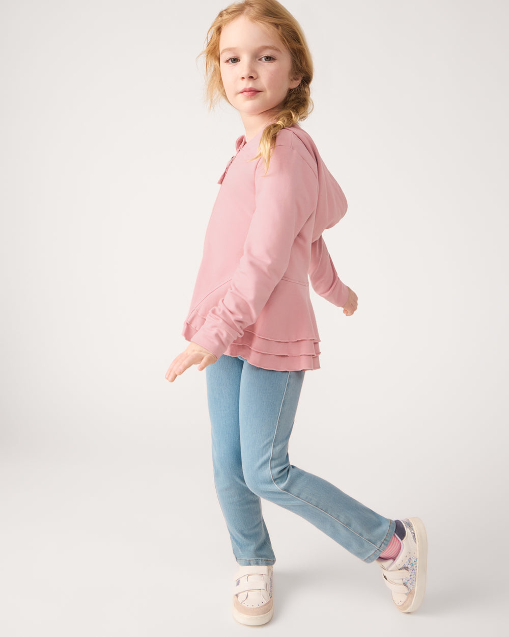 Girl wearing the Light Blue Denim Jegging with a blush zip hoodie