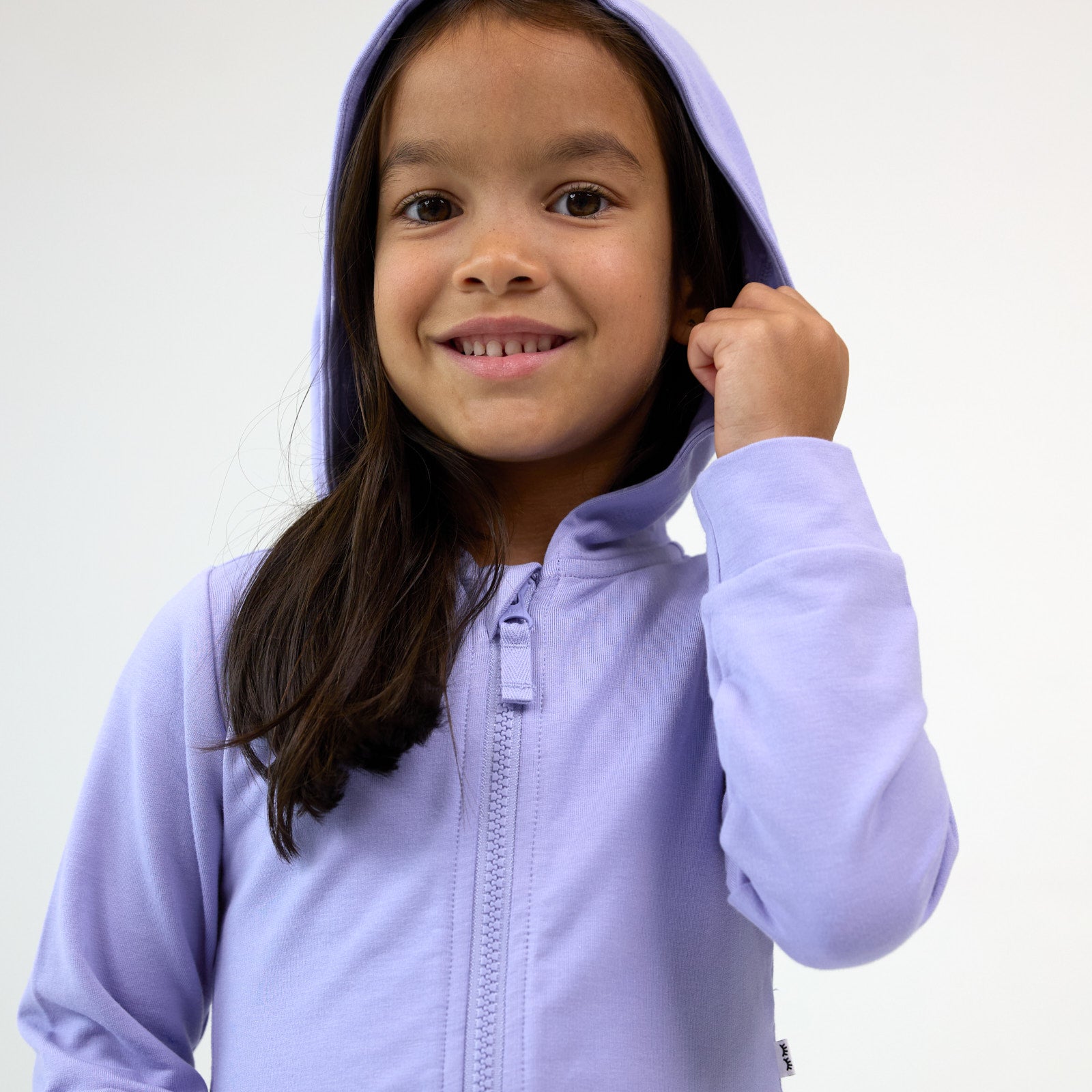 Close up image of girl displaying the hoodie detail up on the Light Iris Peplum Hoodie