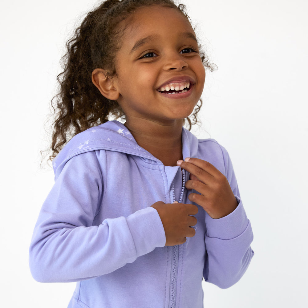 Close up image of girl wearing the Light Iris Peplum Hoodie and showing the zipper detail