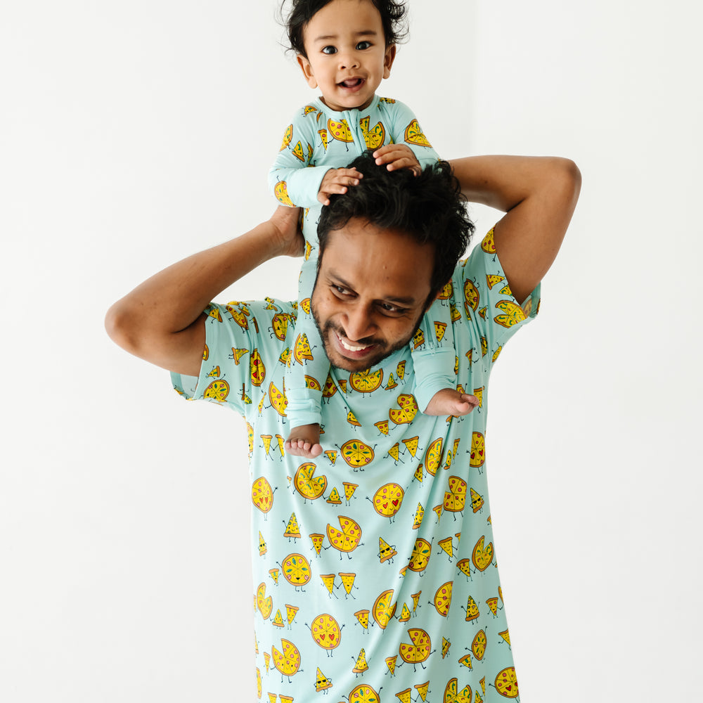 Father and child wearing matching Pizza Pals pajamas. Dad is wearing men's Pizza Pals pj top and child is wearing a matching zippy
