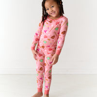 Child wearing a Pink All Stars printed two piece pajama set