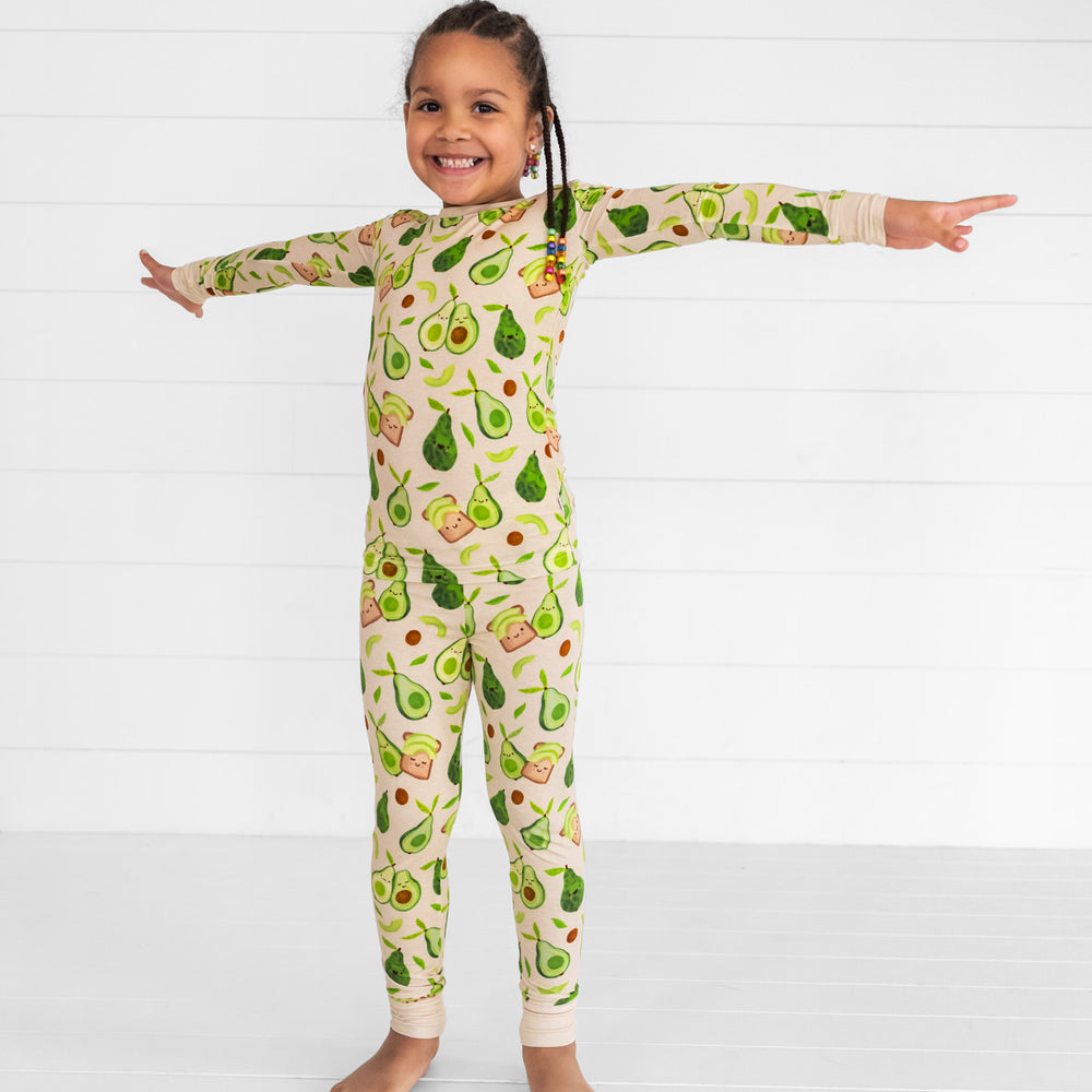 Child posing wearing an Avocado Toast two piece pj set