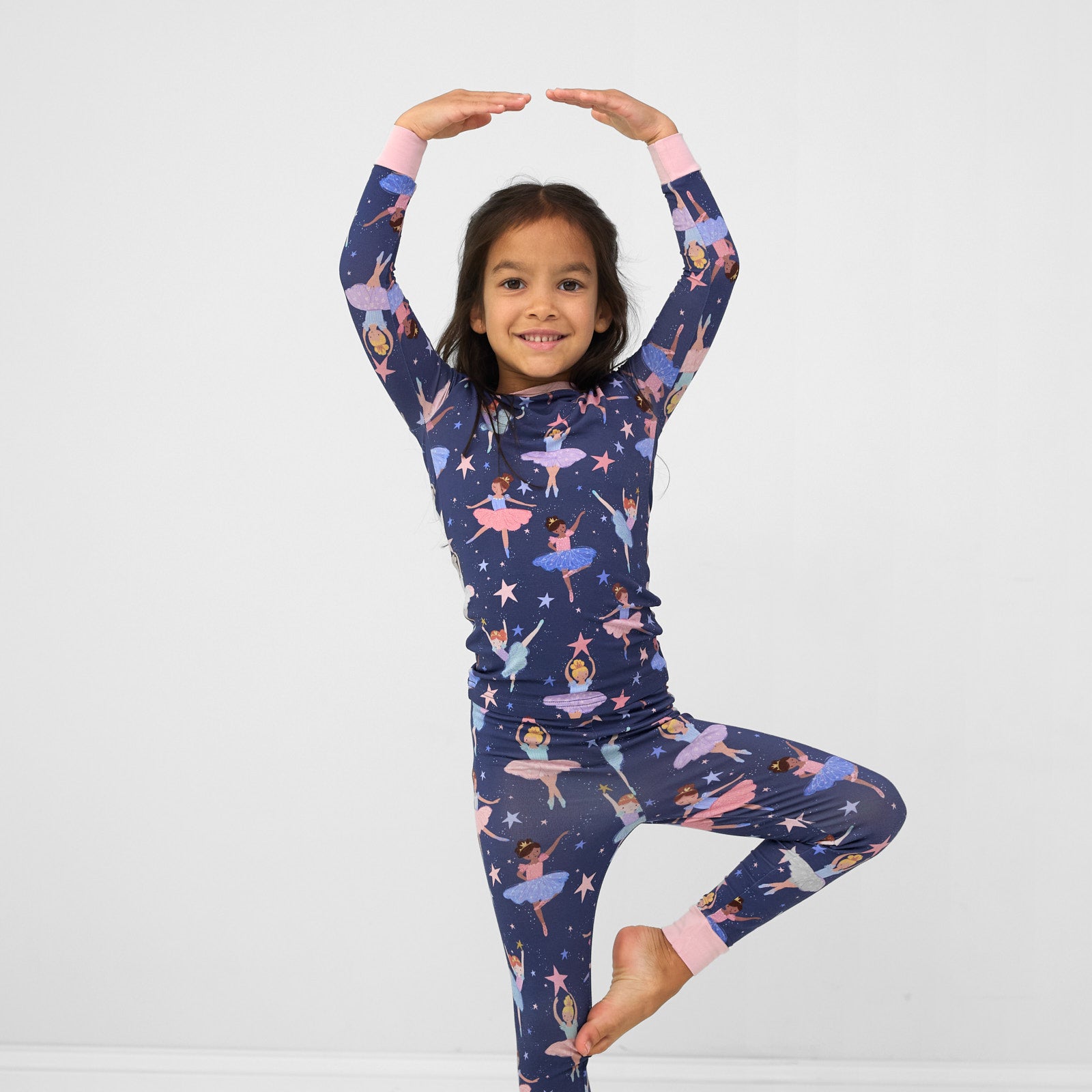 Image of a child posing wearing a Twilight Ballet two piece pj set
