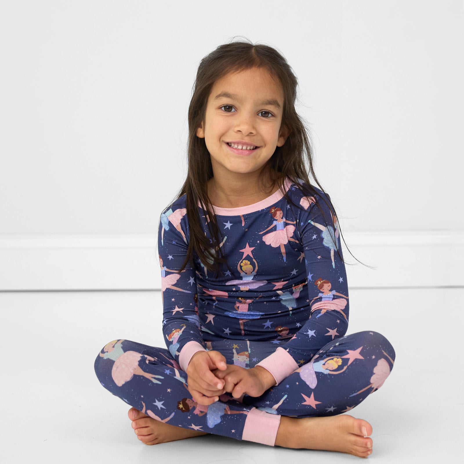 Image of a child sitting wearing a Twilight Ballet two piece pj set
