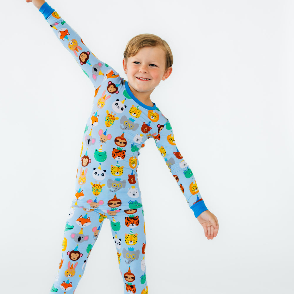 Child posing wearing Blue Party Pals two piece pj set