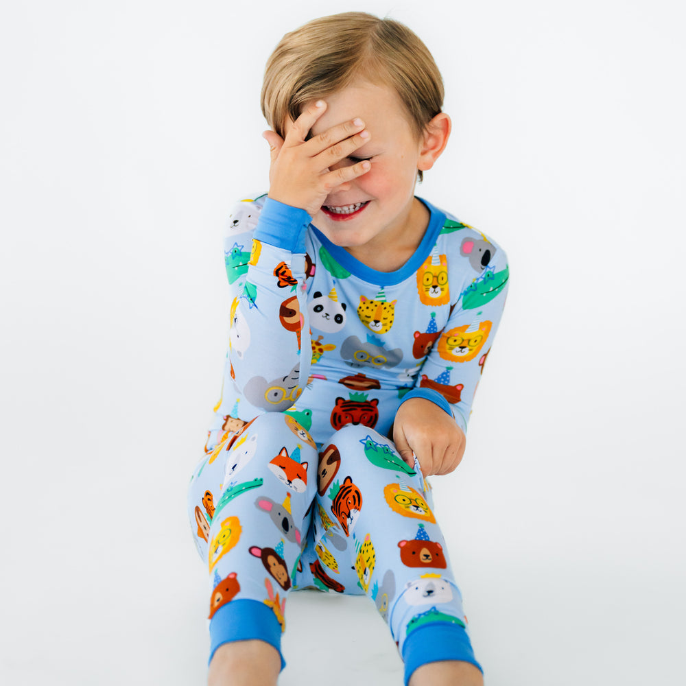 Child sitting wearing Blue Party Pals two piece pj set