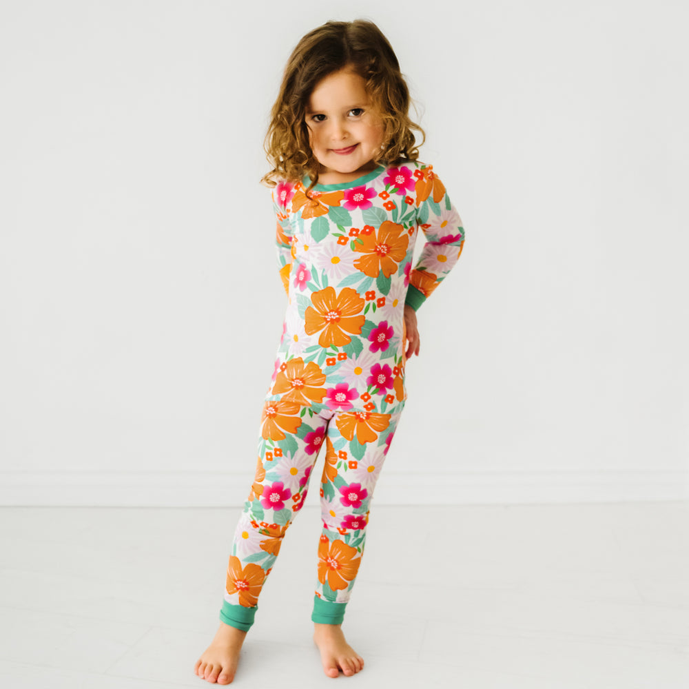 Child posing wearing Beachy blooms two piece pajama set