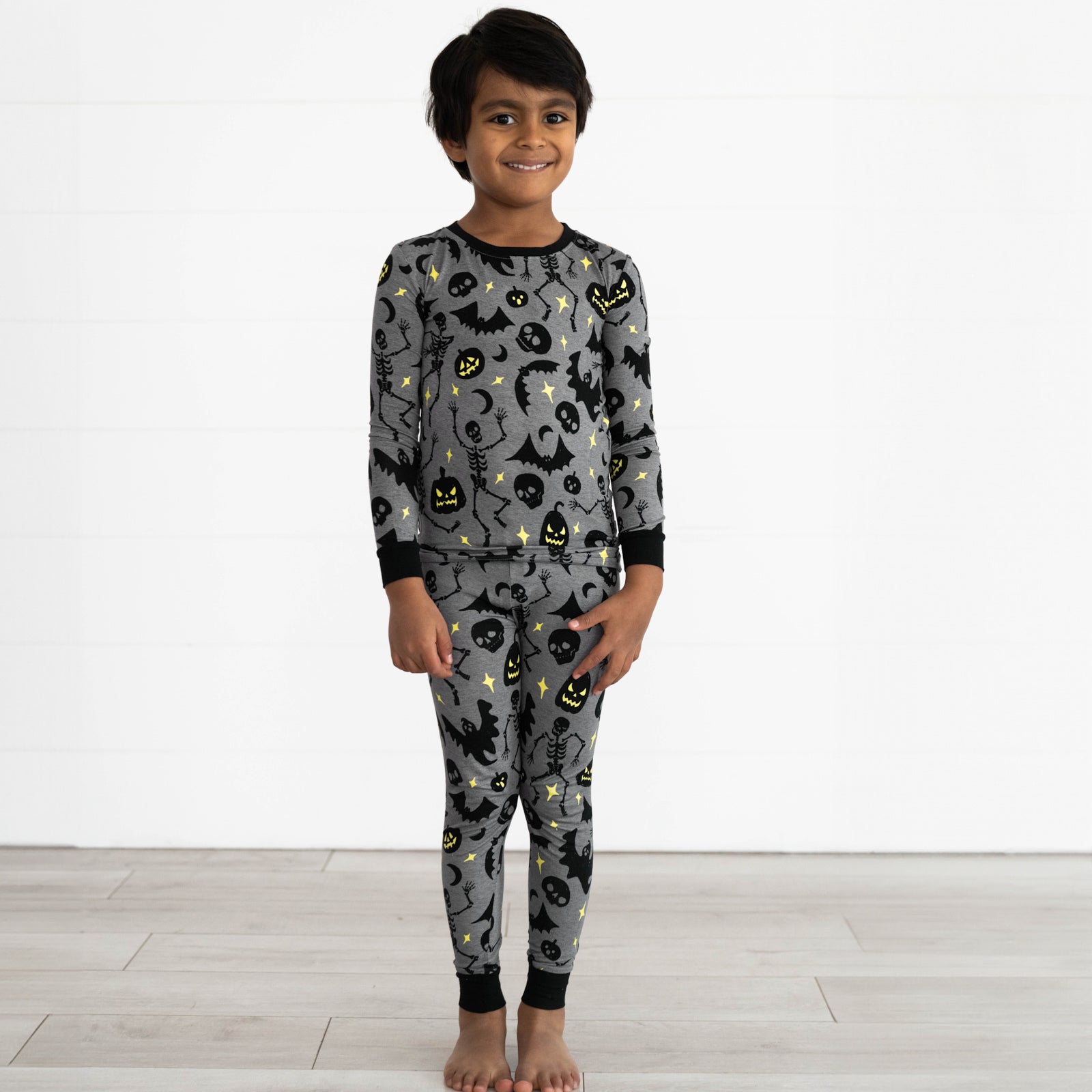 Boy wearing the Gray Glowing Ghouls Two-Piece Pajama Set