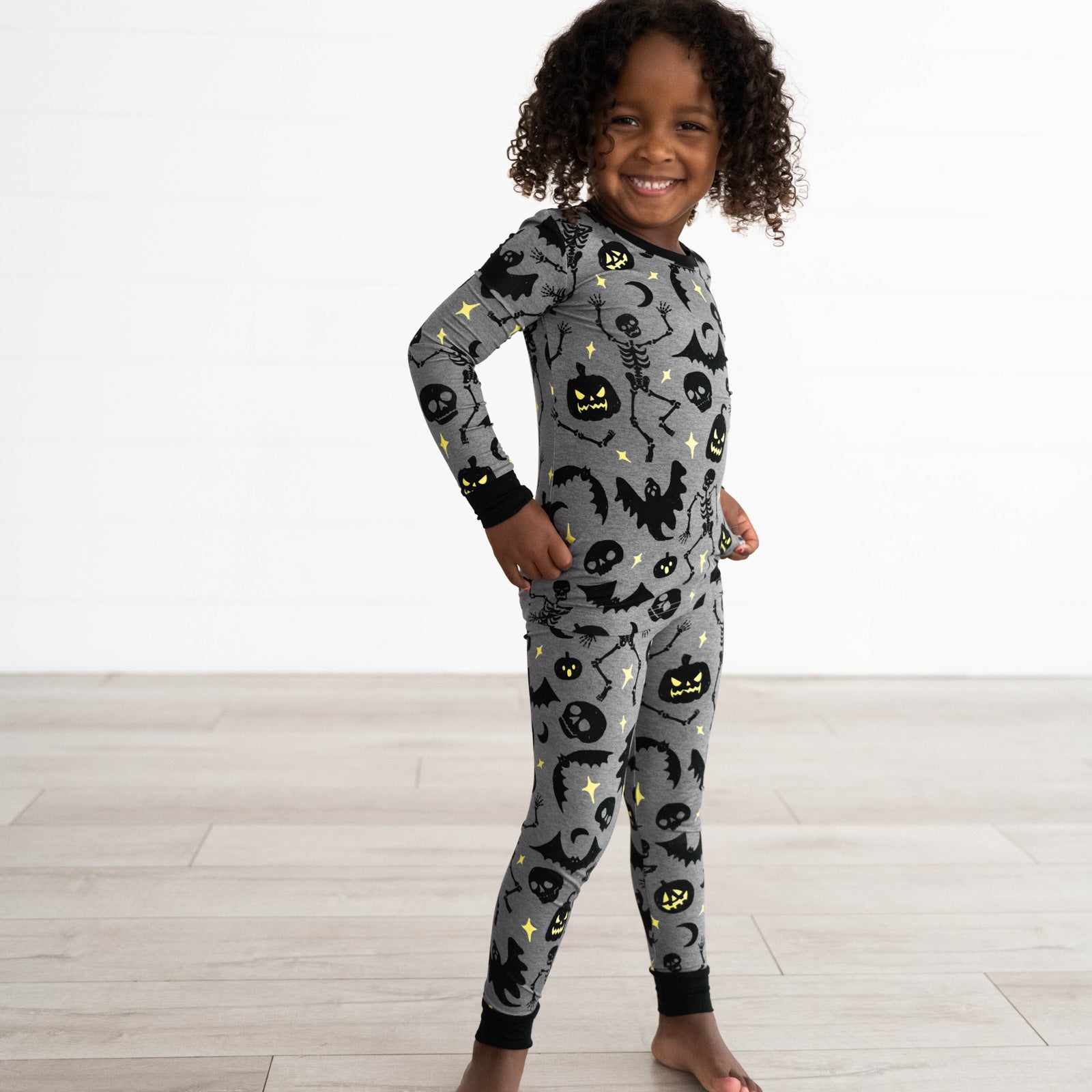 Girl posing in the Gray Glowing Ghouls Two-Piece Pajama Set