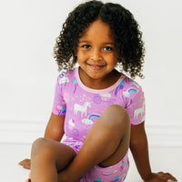 image of a child sitting wearing a Magical Birthday two piece short sleeve and shorts pj set