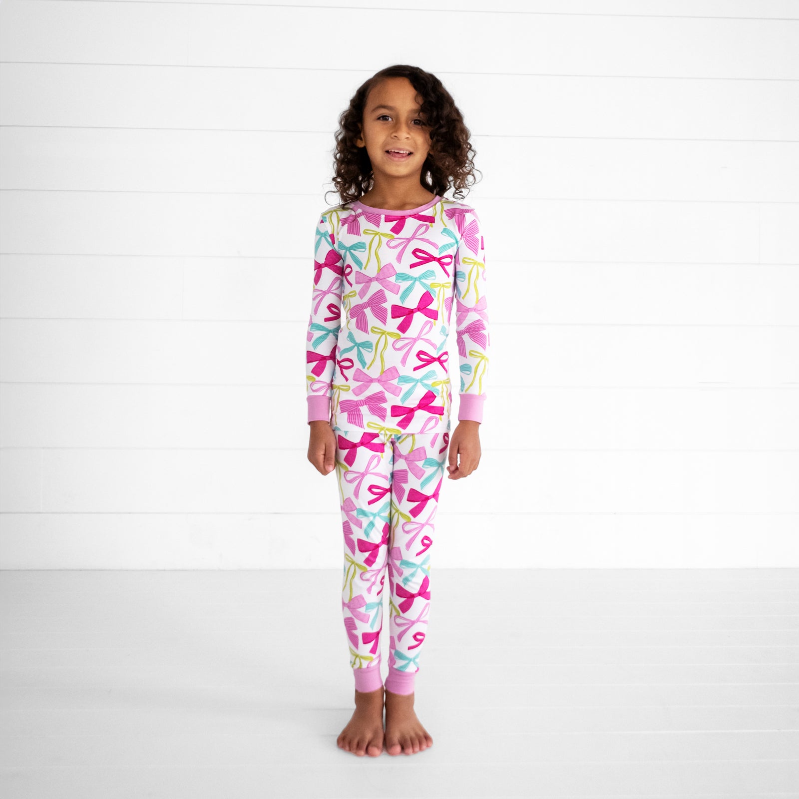 child wearing a Ribbons and Bows two piece pj set