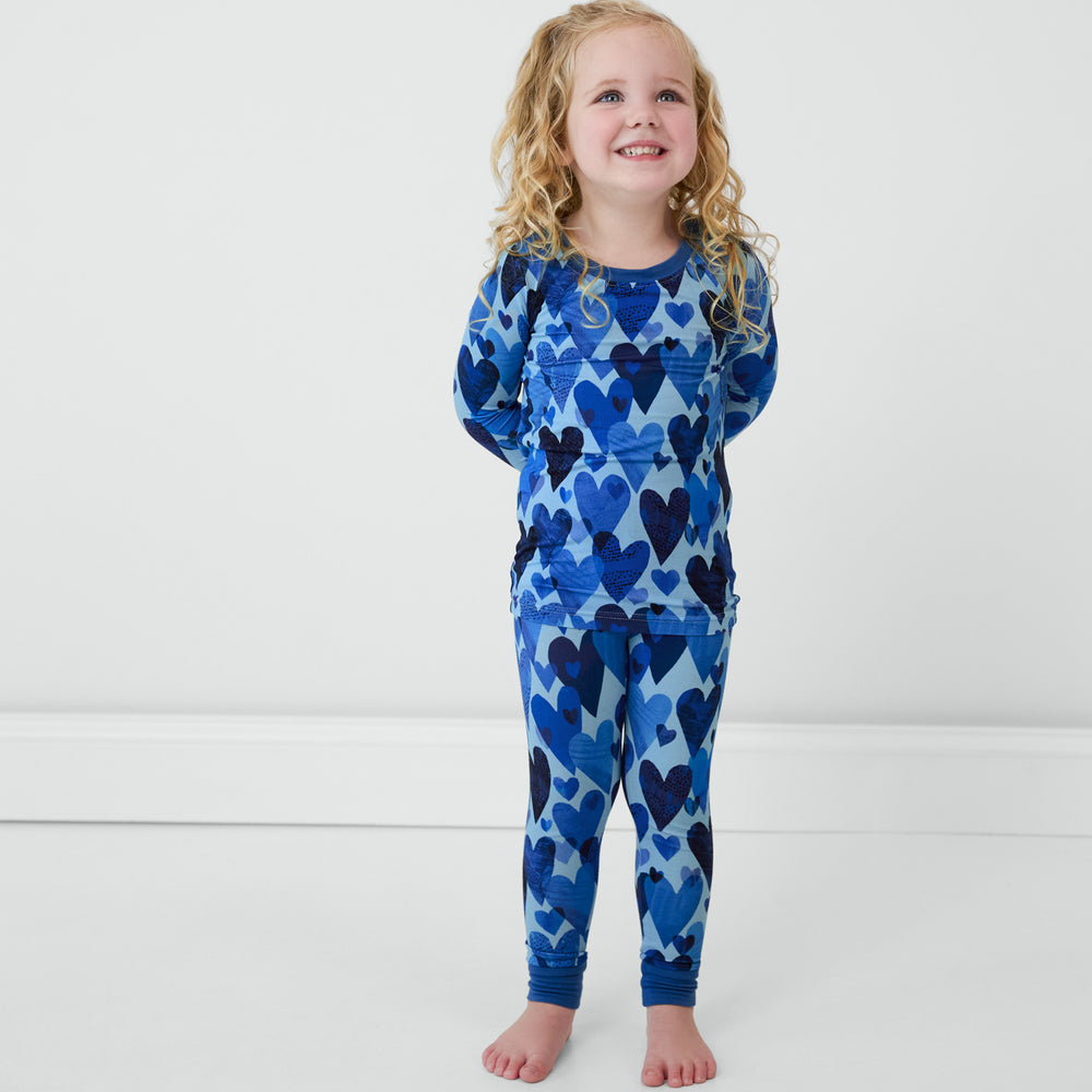 Girl wearing Blue Hearts & Crafts two-piece long sleeve and pants pajama set.