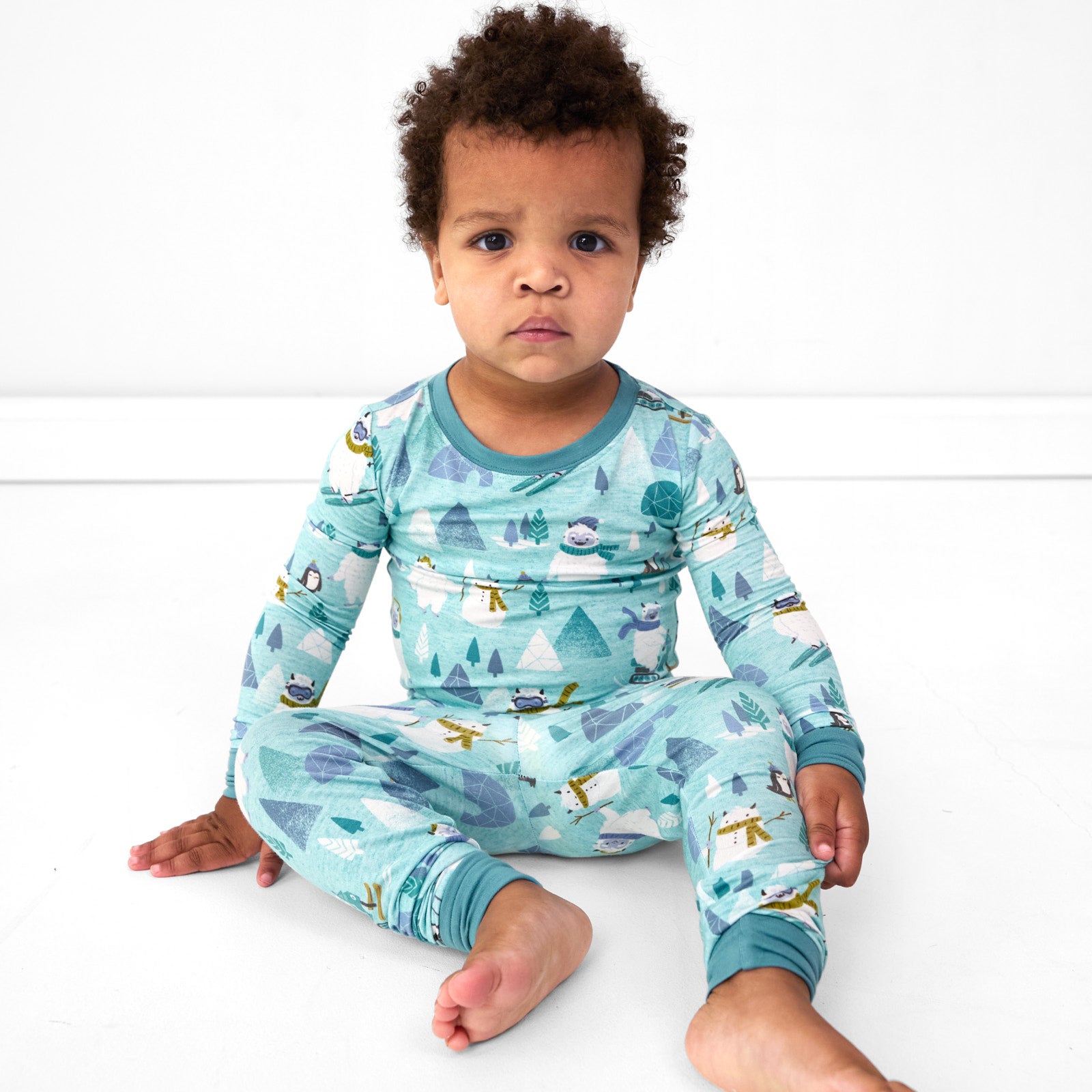 Image of a child sitting wearing a Yeti Snow Day two piece pj set