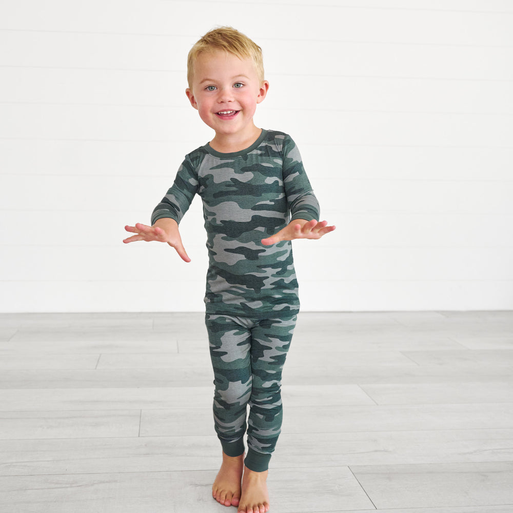 Boy posing while in the Vintage Camo Two-Piece Pajama Set