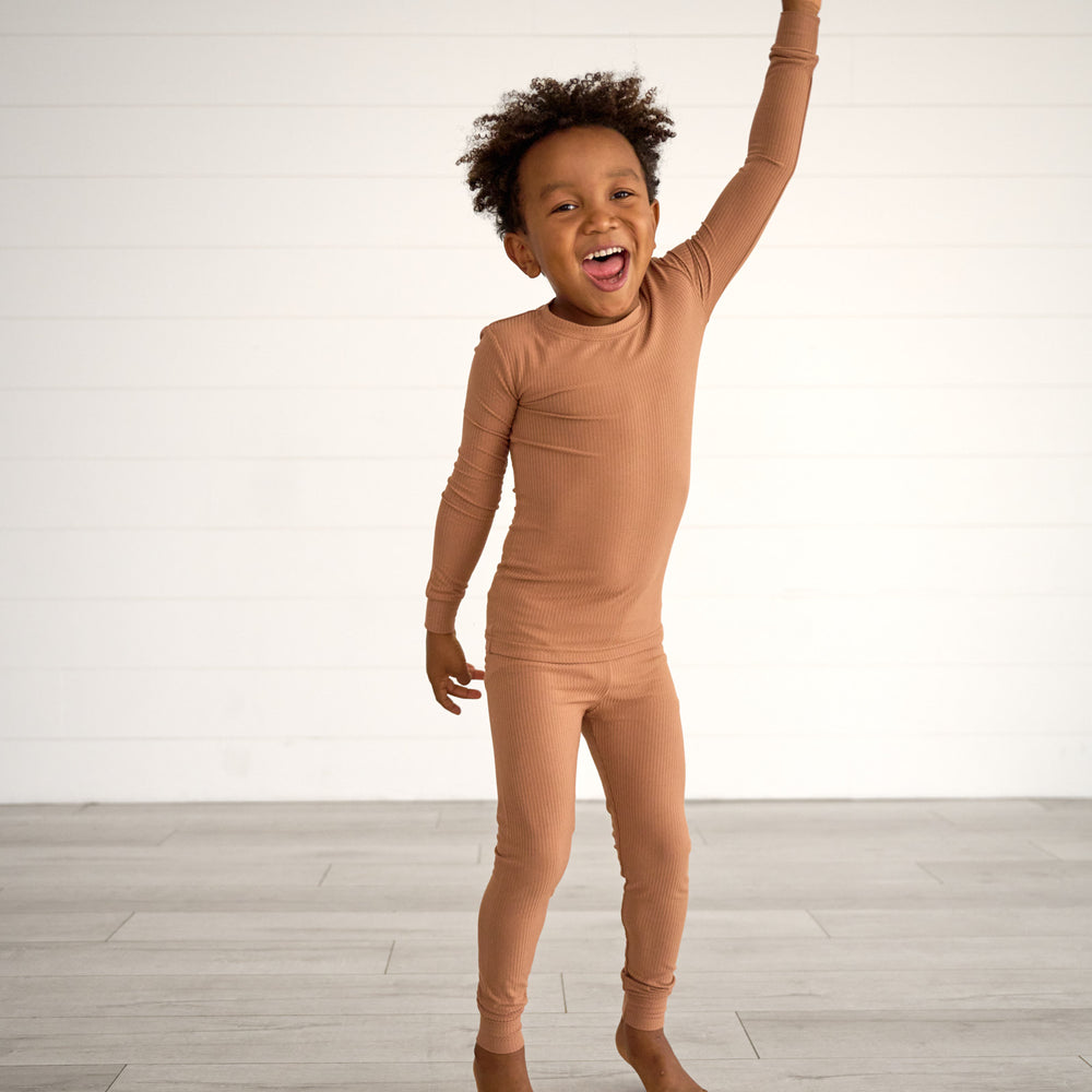 Boy posing while wearing the Caramel Ribbed Two-Piece Pajama Set