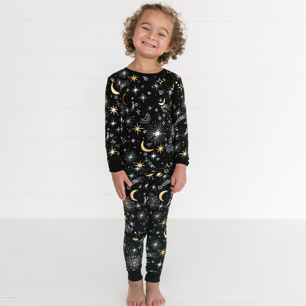 Child posing wearing a Celebration Stars two piece pj set