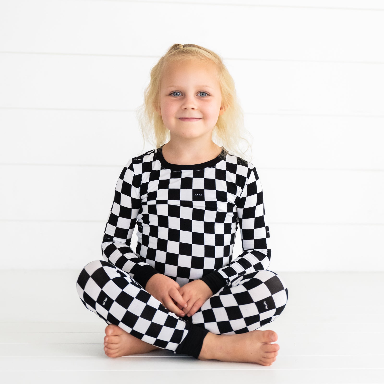 child sitting wearing a Cool Checks two piece pj set