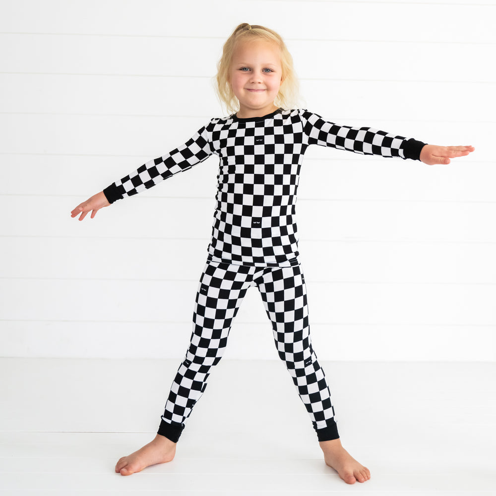 Child posing wearing a Cool Checks two piece pjs set