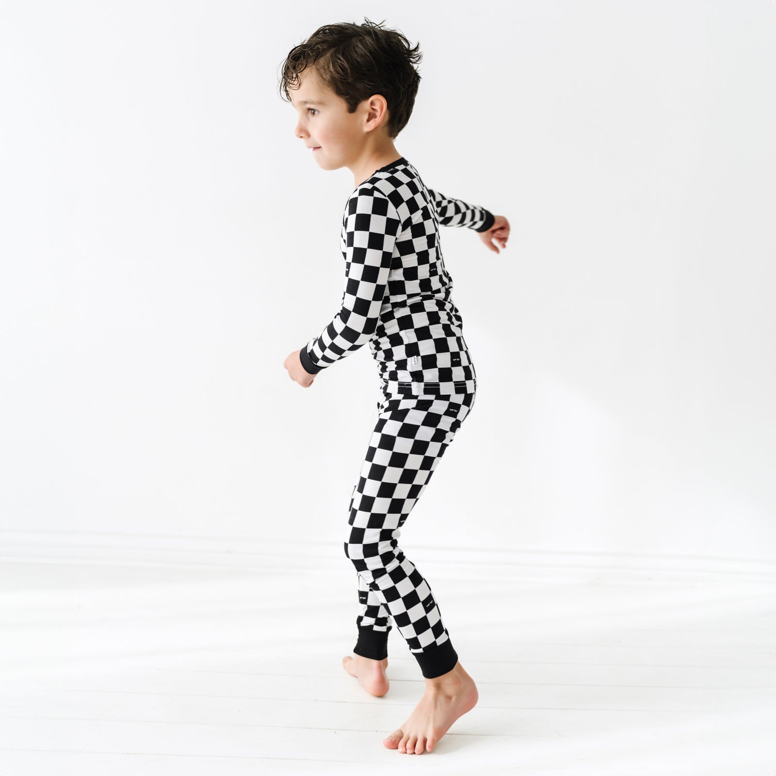 profile view of a child wearing a two piece pj set