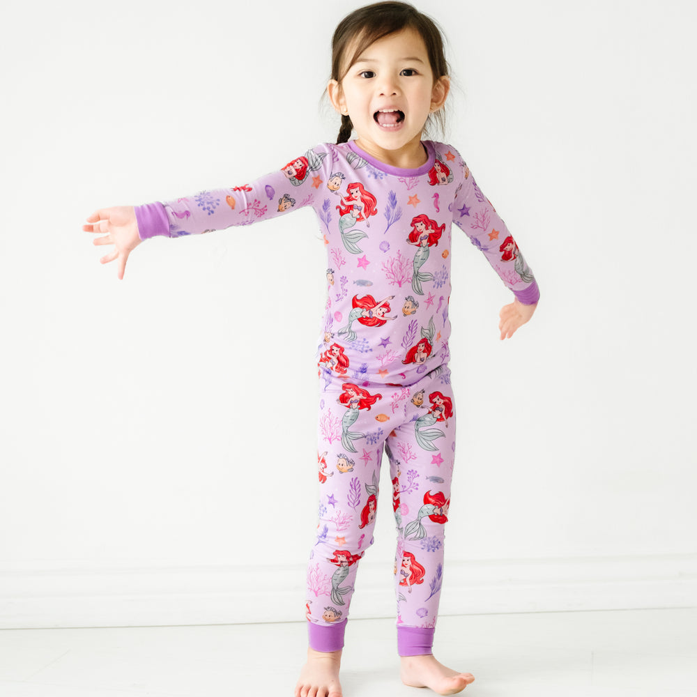 Child playing wearing a Disney Part of Her World two piece pajama set