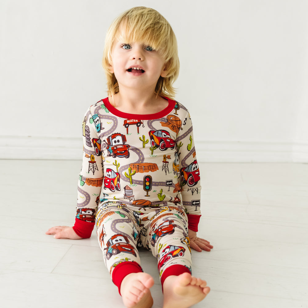 Alternate image of a child sitting wearing Radiator Springs two piece pajama set
