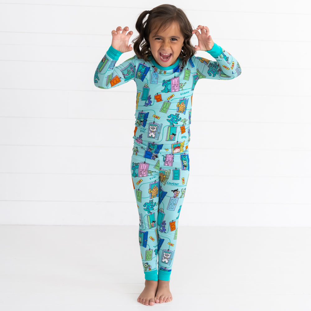 Girl posing while wearing the Disney Monsters, Inc. Scream Team Two-Piece Pajama Set