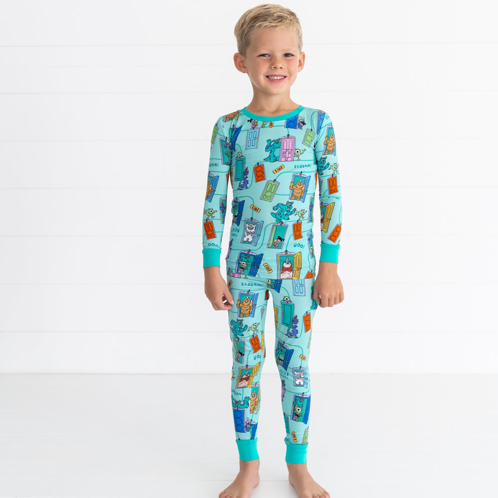 Smiling boy wearing the Disney Monsters, Inc. Scream Team Two-Piece Pajama Set