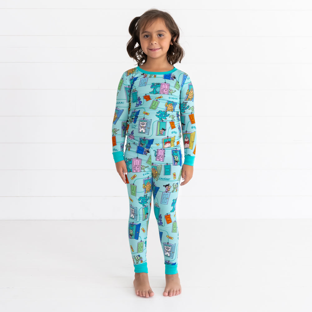 Smiling girl wearing the Disney Monsters, Inc. Scream Team Two-Piece Pajama Set