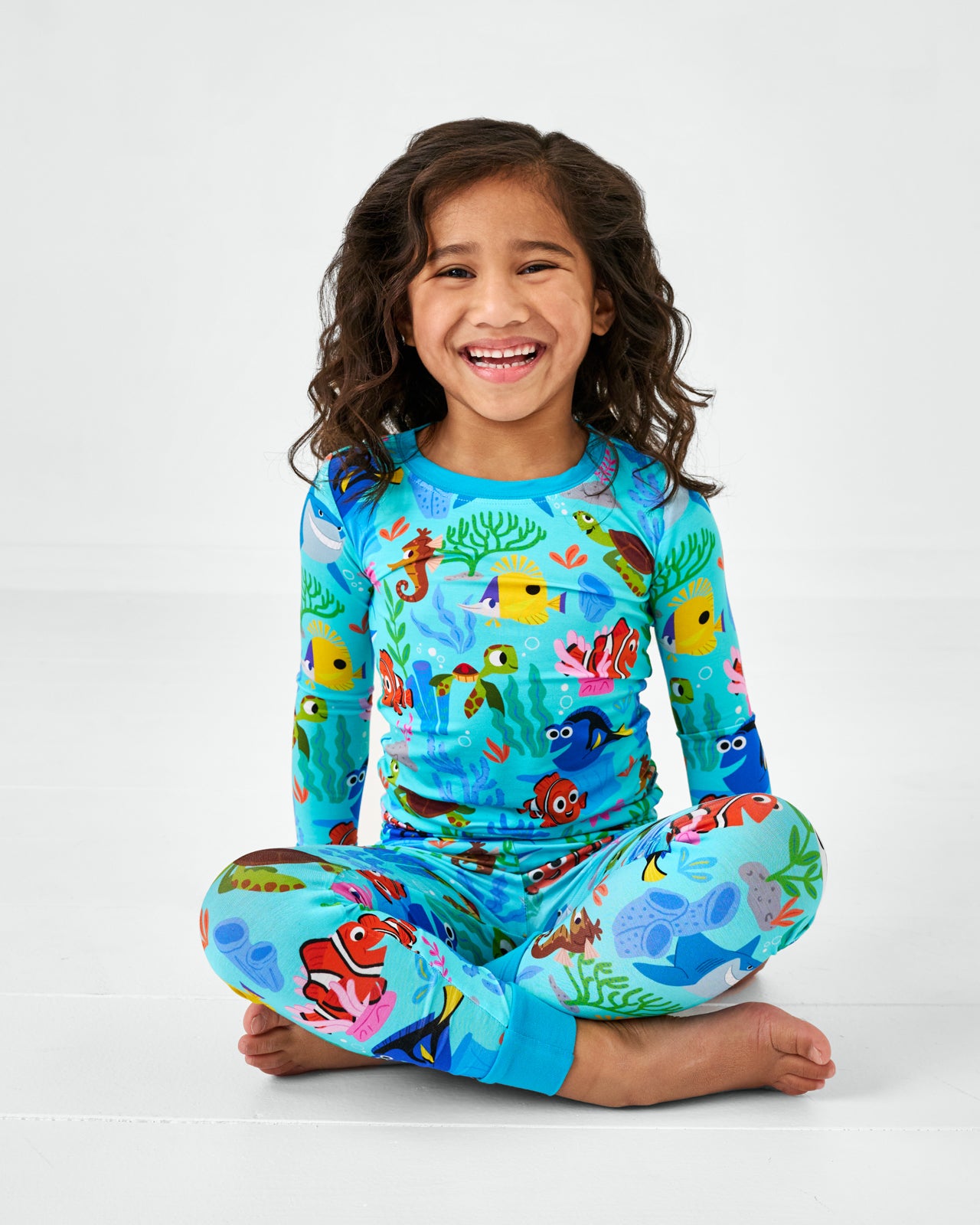Sitting child wearing the Disney Nemo's Reef Two-Piece Bamboo Pajama Set