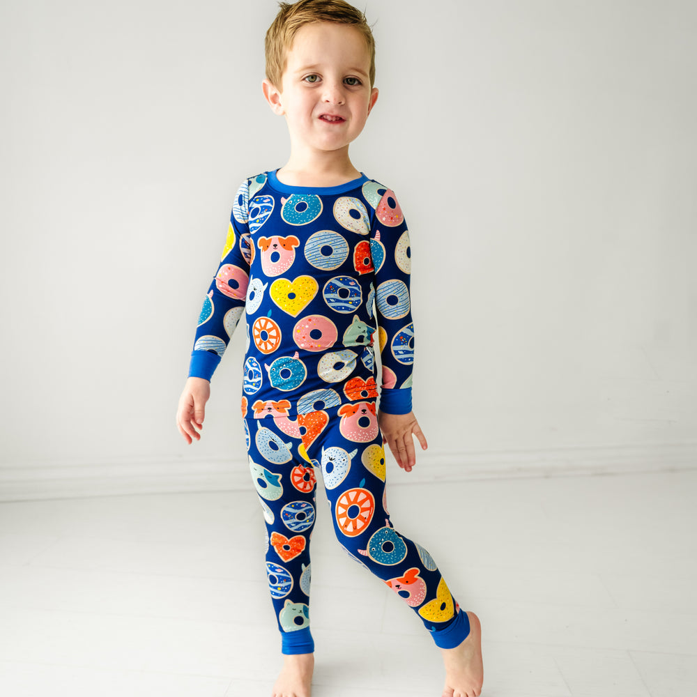 child wearing Blue Donut Dreams two piece pajama set