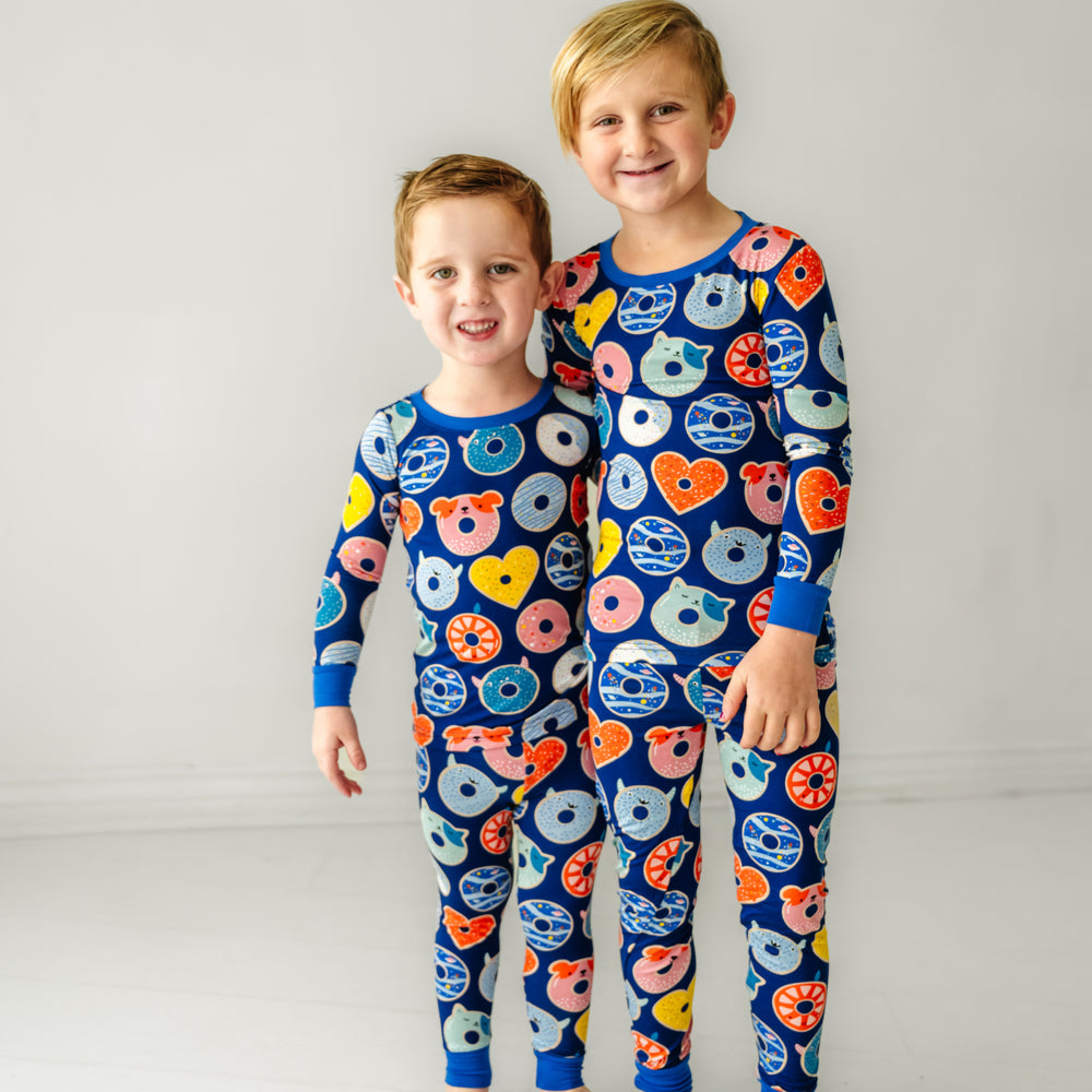 two children cuddling wearing matching Blue Donuts two piece pajama set